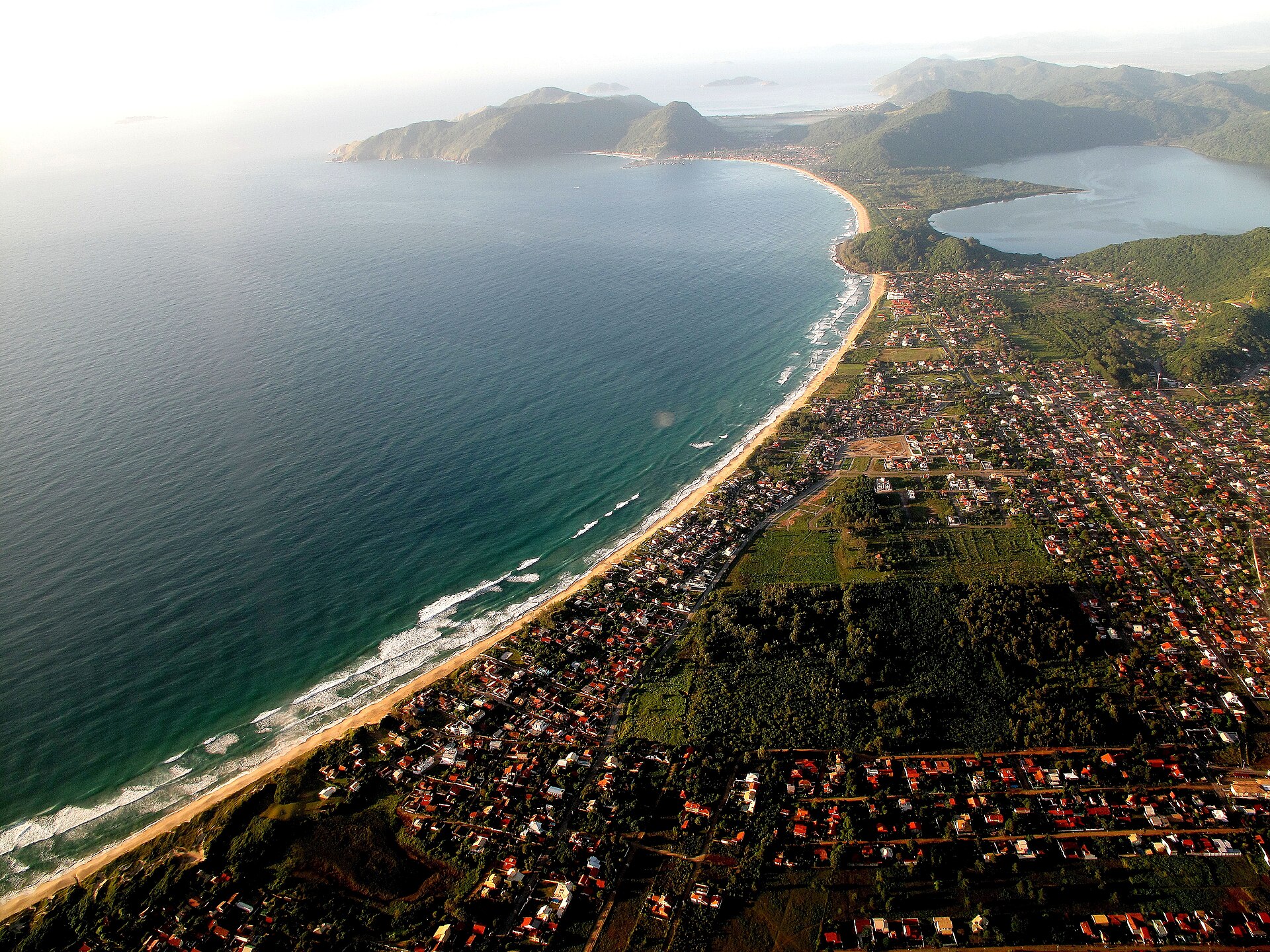 Aerial view of Florianópolis island, beaches and the Hercílio Luz bridge